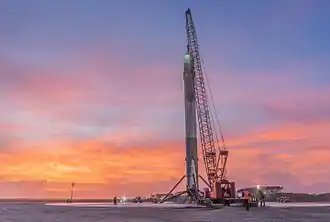 Booster hooked up on a crane