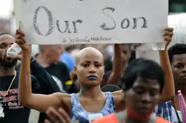 A woman holding a sign in Ferguson