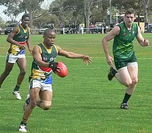 Providing chase as South African player kicks the ball