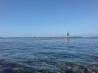 A man fishing just offshore near Gabao Beach.