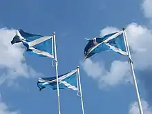 Three flags of Scotland marking the Anglo-Scottish Border.