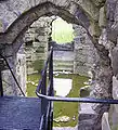 Looking down into the basement of the isolated keep. Part of the vaulted passageway can be seen in the far stairwell.