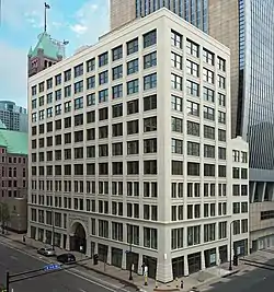 A largely unadorned 11-story office building on a downtown corner lot