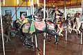 Note the slots in the floor that allow the horses to tilt while the carousel is in motion, an unusual feature.