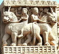 Foreigners holding grapes and riding winged lions, Sanchi Stupa 1, Eastern Gateway.