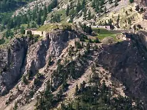 A mountain. Walls can be seen along several flat sections.