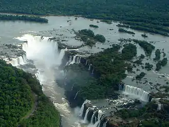 A large waterfall falling into a horseshoe shaped gorge.