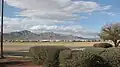 South and North Franklin mountains, shown left to right, El Paso, Texas, as seen from Fort Bliss. The Organ Mountains can be glimpsed to the north, in the right part of the image.