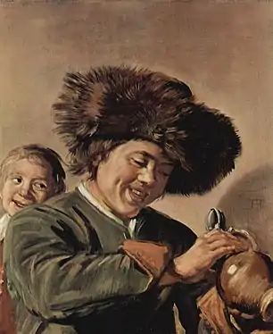 Two laughing boys with mug of beer, with an accomplice on the left