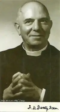 Elderly man, balding, wearing ecclesiastical collar