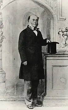 Standing photographic portrait of Frederick Chatfield, with his hand on inverted top hat