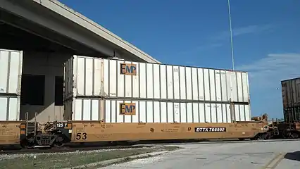 A container train passing through Jacksonville, Florida, with 53' containers used for shipments within North America. Showing one shared truck