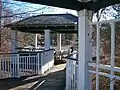 In summer, this gazebo juts out over a small pond.