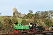 Two ex-CIÉ G Class diesel locomotives in a siding at Downpatrick station. Down Cathedral can be seen above.