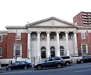 Looking across Main Street in Queens, New York, United States, at a post office. All five boroughs of New York City have streets named "Main Street", but this is the only one that is an arterial road.