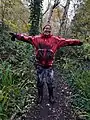 Muddy volunteer after a morning's work in wet woodland