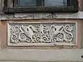 Carving on a house façade in the centre of the village