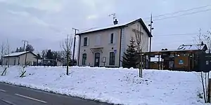 Two-story building with gabled roof in the snow