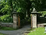 A pair of gateposts with carved skulls