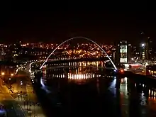 Picture of Gateshead Millennium Bridge at night. The construction of Gateshead Millennium Bridge formed part of wider regeneration projects in both Newcastle (pictured left) and Gateshead (pictured right).