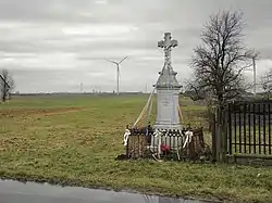 Wayside cross in Gaworzyna. Wind turbines in the distance.