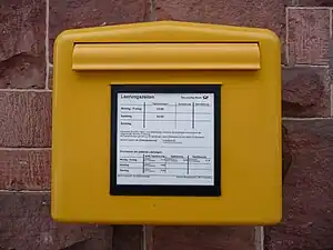 A mailbox in Germany. Yellow was the color of the early postal service in the Habsburg Empire.