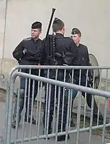 Gendarmes mobiles equipped with shields, FAMAS and gas mask.