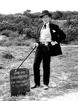 Gene Barry as Bat Masterson standing next to Lester Moore's grave in 1960