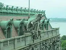 View of the upper facade of the Alexander Hamilton U.S. Custom House, with architectural sculptures, from an adjacent building, in Manhattan.