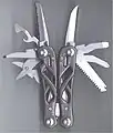 A Gerber "Suspension" multi-tool, with skeleton handle and locking blades.  Blades are accessible with tool closed, and knife blades have a thumb stud for one handed opening.