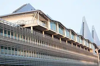 The façade of the building, with the offices on the lower floors and courts on the top floor