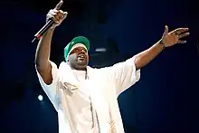 Ghostface Killah performing on stage holding a microphone.