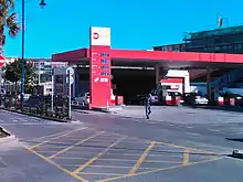 A petrol station forecourt viewed from across the road