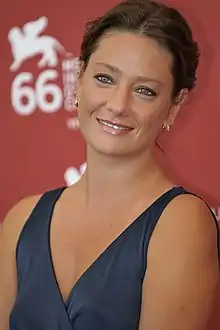 Giovanna Mezzogiorno at 2009 Venice Film Festival, wearing a dark blue dress and smiling