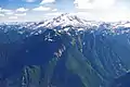 Painted Mountain (left of center, nearest to camera) with Glacier Peak centered at top. Southwest aspect as seen from Sloan Peak in 1999.