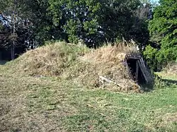 Small house built into small, grassy hill