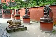 Statues of Nandi (in the foreground), Pande and his two wives, Vishnu, bearded Brahma, Brindi Bhairab and Nandi Bhairab (along the wall from left to right)