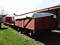 La Class open wagon, two N Class flat wagons, and a guard's van sit in the yard at Little River on a small section of track.