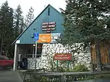 Post office at Government Camp with a sign describing its naming