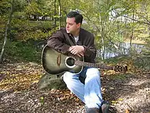 Graham Clarke in 2005 (holding Delores, one of his guitars)