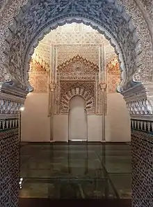 A small room with some Arabic decoration on the wall