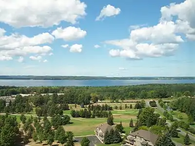 The East Arm of Grand Traverse Bay from the east, with the Old Mission Peninsula in the background.  Hills of the Leelanau Peninsula are faintly visible on the horizon.