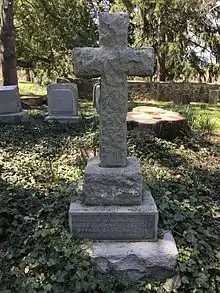 A cross-shaped gravestone.