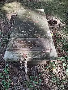 Flat gravestone with metal plaque attached