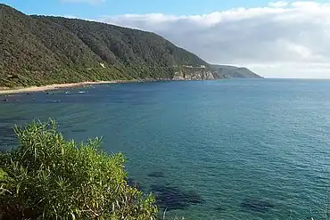 The Great Ocean Road winds along the coastline of Victoria, offering spectacular views of the Bass Strait and Southern Ocean