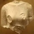 A fragmentary torso of Nefertiti.