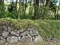 Basalt dry-stone wall with former site of Green Hill in distance