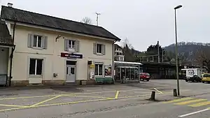 Two-story yellow station building with hip roof