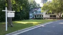 White house with a sign in the front reading "Union-Philanthropic Literary Society"