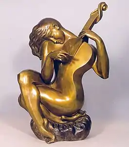 Sculpture of a nude woman playing a guitar